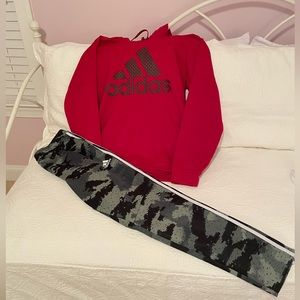 Adidas hoodie and Tiro track pants.